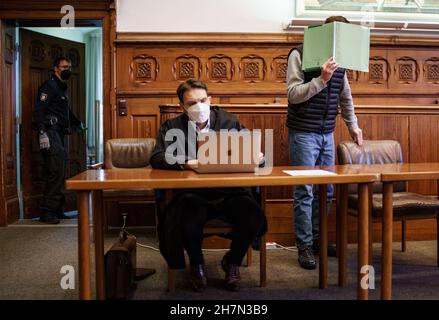 Flensburg, Germania. 24 novembre 2021. Il 20-anno-vecchio convenuto nel processo di manmacello attende nella sala di tribunale accanto al suo avvocato Christian Steinhardt (M) per l'annuncio del verdetto. Il giovane uomo sarebbe stato ucciso il 2 aprile 2021 da 16 anni dopo un'argomentazione su una piattaforma di osservazione nei pressi della Duborgskolen a Flensburg. Credit: Axel Heimken/dpa/Alamy Live News Foto Stock