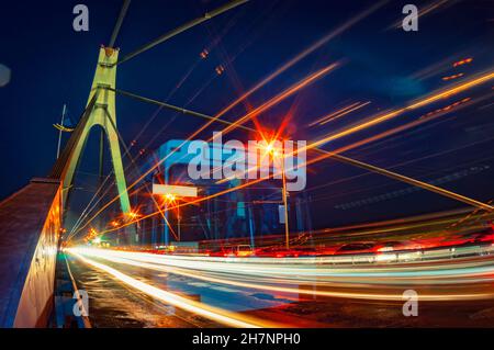 Il traffico di notte sul ponte. Coloratissima scena urbana a Kiev, Ucraina Foto Stock