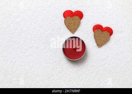 San Valentino amore coppia. Due cuori e una candela sulla neve bianca. Foto Stock