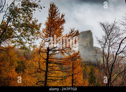 Sacro di San Michele arroccato sulla collina del Monte Pirchiriano, ai piedi delle Alpi italiane, in una mattinata di nebbia - San Pietro, Torino, Italia Foto Stock