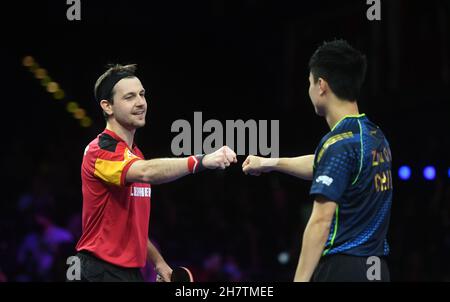 Houston. 24 novembre 2021. Timo Boll (L) della Germania saluta Zhou Qihao della Cina dopo il singolo turno maschile di 64 match tra Timo Boll della Germania e Zhou Qihao della Cina alle finali dei campionati mondiali di tennis da tavolo 2021 a Houston, gli Stati Uniti il 24 novembre 2021. Credit: WU Xiaoling/Xinhua/Alamy Live News Foto Stock