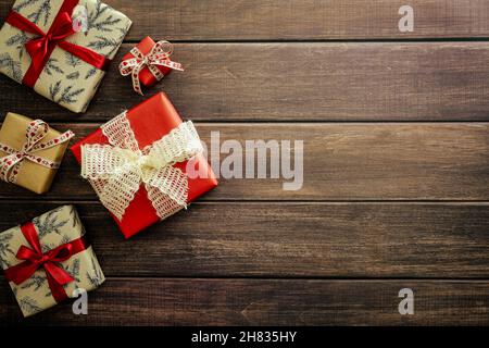 Regali di Natale su tavola in legno vista dall'alto. Vintage Merry Natale e Happy New Year biglietto d'auguri modello Foto Stock