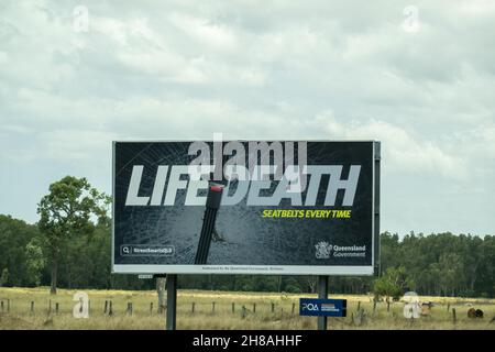 Bruce Highway, da Townsville a Mackay, Queensland, Australia - Novembre 2021: Segnale di sicurezza stradale relativo all'uso delle cinture di sicurezza Foto Stock