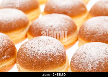 Molti 'Krapfen' conditi con zucchero a velo Foto Stock