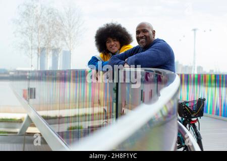Ritratto felice padre e figlio sulla passerella urbana Foto Stock