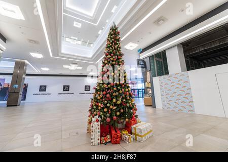 Minsk, Bielorussia - Nov 25, 2021: Foto di un albero di Natale verde con palline luminose e regali in scatole in un centro commerciale. Natale e Capodanno Foto Stock