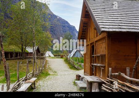 Villaggio vichingo in Norvegia con case in legno, tende con montagne circostanti. Fiordo norvegese paesaggio Foto Stock