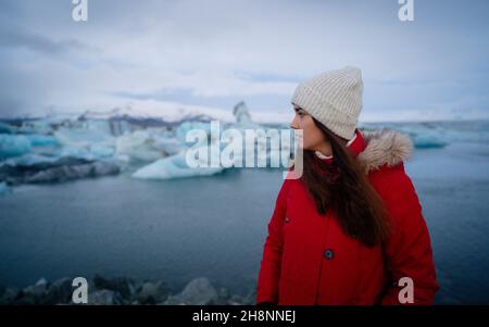 Islanda viaggio turistico godendo di vista del paesaggio naturale Jokulsarlon laguna glaciale in Islanda. Donna in piedi all'aperto da destinazione turistica Foto Stock