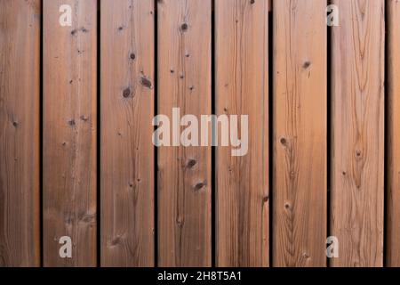 tavole verticali con nodi, dipinte di un colore arancione chiaro Foto Stock