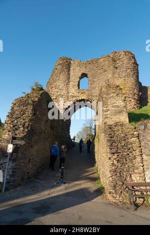 Launceston, Cornovaglia, Inghilterra, Regno Unito. 2021. I visitatori camminano attraverso il cancello d'ingresso al Castello di Launceston in Cornovaglia. Foto Stock