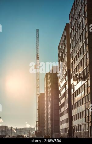 Gru industriali e nuovo edificio a più piani Foto Stock