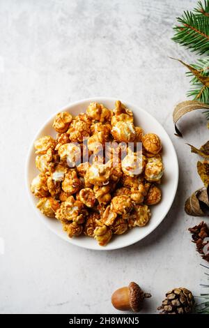 Popcorn caramello su sfondo natalizio, fuoco selettivo Foto Stock