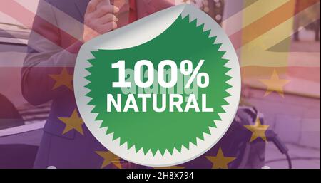 simbolo naturale del 100% rispetto all'uomo con auto elettrica e bandiere britanniche ed europee Foto Stock