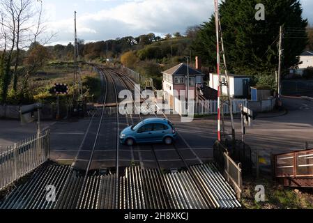 Crediton, Devon, Inghilterra. 2021. Panoramica della barriera di attraversamento a livello aperta al traffico a Crediton lungo la linea ferroviaria per Okehampton e Barnstable Foto Stock