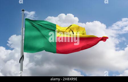 Bandiera del Benin che sventola su un palo in un cielo blu Foto Stock