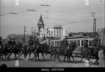 Warszawa, 1947-04-13. Uroczyste rozwi¹zanie 1 Warszawskiej Dywizji Kawalerii. Przekazanie sztandarów 2 i 3 Pu³ku U³anów Wojska Polskiego do Muzeum Wojska Polskiego. NZ. kawalerzyœci wracaj¹ do koszar. Przeje¿d¿aj¹ przez plac Trzech Krzy¿y. W Tle Ruiny koœcio³a œw. PAP. wb Aleksandra Varsavia, 13 aprile 1947. Scioglimento cerimoniale della prima Divisione Cavalleria di Varsavia. Gli striscioni del 2° e 3° reggimento Uhlan dell'esercito polacco sono stati consegnati al Museo dell'esercito polacco. Nella foto: Cavalieri che tornano alle caserme passando attraverso Piazza Trzech Krzyzy. Sullo sfondo le rovine della Chiesa di San Alessandro Foto Stock