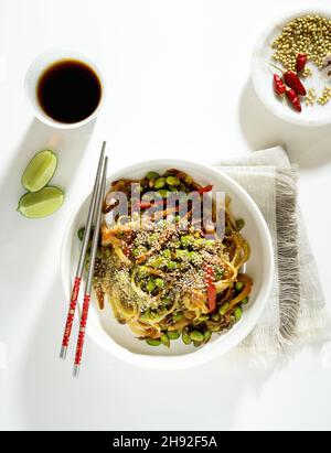 tampone vegano tailandese con tofu e fagioli edamame in un piatto bianco Foto Stock