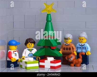 Tambov, Federazione russa - 01 dicembre 2021 Un Lego nonni, nipoti e minifigure di gatto in piedi vicino ad un albero di Natale con regali Foto Stock