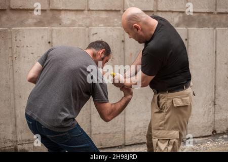 L'istruttore di Kapap dimostra le tecniche di autodifesa contro una pistola Foto Stock