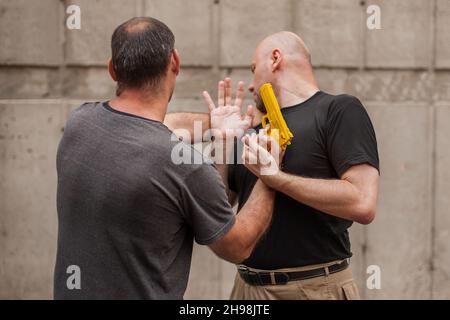 L'istruttore di Kapap dimostra le tecniche di autodifesa contro una pistola Foto Stock