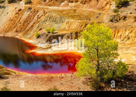 Pericoloso sangue colorato con inquinamento di rame lago di miniera di Sha, Nicosia, Cipro Foto Stock