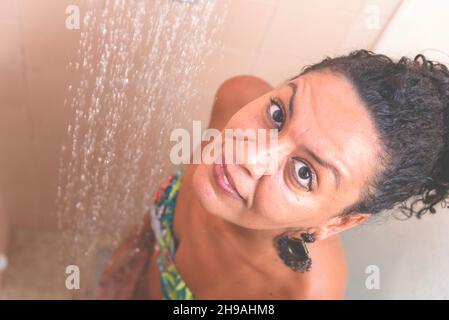 Ritratto di una donna in bagno lavaggio se stessa. Salvador, Bahia, Brasile. Foto Stock