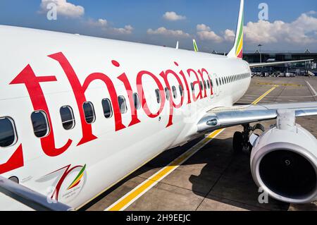 Addis Abeba, Etiopia - 23 aprile 2019: Compagnie aeree etiopi Boeing 737 in attesa a terra il giorno di sole, Bole International Airport building a backgrou Foto Stock