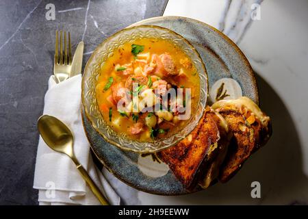 Zuppa di prosciutto e fagiolo con salsiccia di kielbasa e panini con formaggio alla griglia gouda Foto Stock