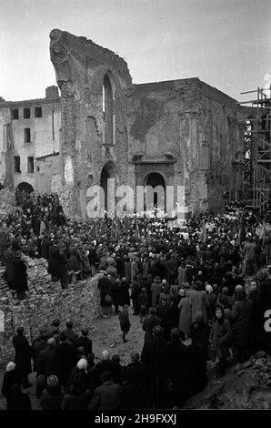 Warszawa, 1948-03-21. Uroczystoœæ przeniesienia cudownej figury Chrystusa z koœcio³a Karmelitów do kaplicy Baryczków w katedrze œw. Jana Chrzciciela na Starym Mieœcie. Wierni s³uchaj¹ kazania sekretarza generalnego Konferencji Episkopatu Polski biskupa Zygmunta Choromañskiego pomiêdzy ruinami katedry. wb PAP Varsavia, 21 marzo 1948. La cerimonia di trasferimento della figura miracolosa di Cristo dalla Chiesa Carmelitana alla Cappella Baryczkow nella Cattedrale di San Giovanni nella Città Vecchia. Nella foto: I fedeli ascoltano il vescovo Zygmunt Choromanski, segretario generale della Conferenza di Pol Foto Stock