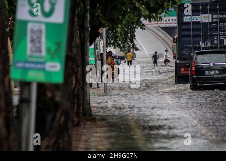 Makassar, Sulawesi meridionale, Indonesia. 7 Dic 2021. Un certo numero di veicoli passa durante il tempo estremo nella città di Makassar. Il clima estremo che si è verificato per diversi giorni a Makassar City ha fatto un certo numero di strade allagate. (Credit Image: © Herwin Bahar/ZUMA Press Wire) Foto Stock