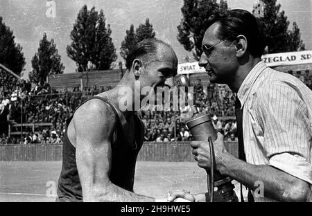 Warszawa, 1948-08. Pierwsze ogólnopolskie Igrzyska Sportowe Zwi¹zków Zawodowych (19-22.VIII) na stadionie Wojskowego Klubu Sportowego Legia, w których rywalizowali w 11 dyscyplinach reprezentanci 17 zwi¹zków zawodowych. NZ. Zawody bokserskie, zwyciêzca w wadze pó³œredniej Gr¹dkowski (Budowlani) przyjmuje gratulacje od sprawozdawcy Polskiego Radia Tadeusza Pyszkowskiego. ka PAP Dok³adny dzieñ wydarzenia nieustalony. Varsavia, 1948 agosto. La prima competizione sportiva sindacale nazionale (agosto 19-22) che si tiene allo stadio del Club militare sportivo Legia. La manifestazione ha riunito la rappresentatività Foto Stock