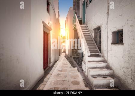 Vicolo stretto nella città di Mykonos al tramonto. Foto Stock