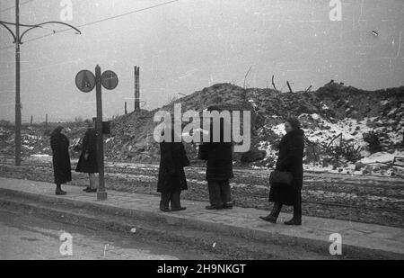 Warszawa, 1948-12. W grudniu ukoñczono uk³adanie torowiska i bruku na ul. Marcelego Nowotki, umo¿liwi³o to uruchomienie komunikacji tramwajowej ³¹cz¹cej ¯oliborz ze Œródmieœciem stolicy. pasa¿erowie na przystanku tramwajowym i autobusowym. uu PAP Dok³adny dzieñ wydarzenia nieustalony. Varsavia, 1948 dicembre. Sono state poste le piste del tram e una strada è stata pavimentata in via Marcelego Nowotki che ha permesso di avviare una linea di tram che collegava il quartiere di Zoliborz con il centro della città a dicembre. Nella foto: Passeggeri alla fermata del tram e dell'autobus. uu PAP Foto Stock