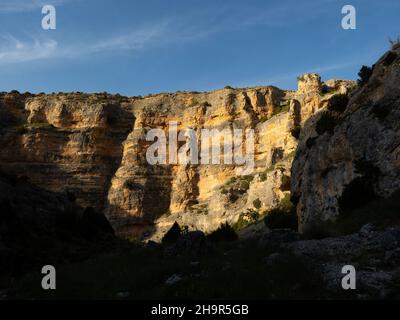 Vista delle pareti di roccia rossa a 'Barranco de la Hoz Seca' a Jaraba (Saragozza) durante una giornata nuvolosa d'estate. Foto Stock