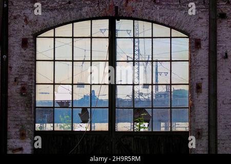 Vista dalla vetrina di un'officina della stazione ferroviaria, luogo perduto, stazione ferroviaria disutilizzata, officina abbandonata, veicolo ferroviario, ferrovia Foto Stock