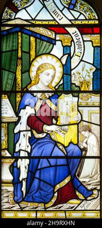 Particolare di vetrate raffiguranti Saint Cecilia, probabilmente di Federico Charles Eden (1864-1944) Barsham chiesa, Suffolk, Inghilterra, Regno Unito non Foto Stock