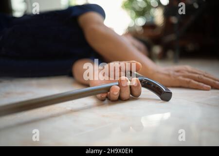 Uomo anziano che cade a casa a causa di inciampato su un marciapiede porta Foto Stock