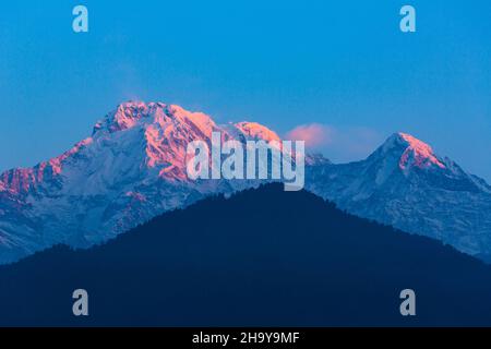 Bagliore di prima luce su Annapurna Sud con Hiunchuli nella catena Annapurna degli Himalaya, come visto da Dhampus, Nepal. Foto Stock