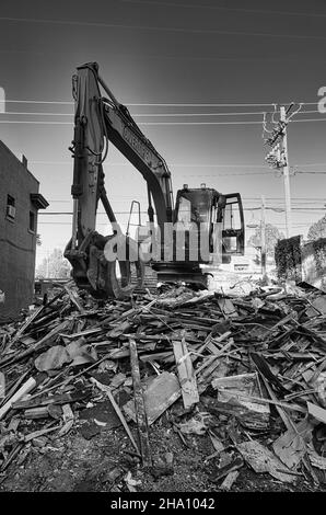 Scatto verticale in scala di grigi di un escavatore nel cantiere Foto Stock