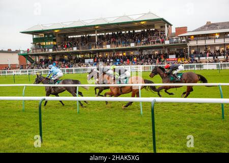 Caccia nazionale all'ippodromo di Warwick, Inghilterra, Regno Unito, con azione davanti allo stand principale della riunione di dicembre Foto Stock