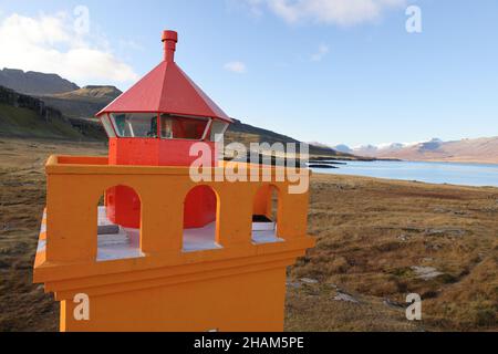 Il piccolo faro arancione di Hafnarnes dell'Islanda orientale Foto Stock