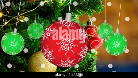 Primo piano di baubles rossi e verdi appesi sull'albero di natale decorato Foto Stock