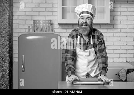 Chef professionista che cucinano in cucina a casa, preparando la cena. Foto Stock