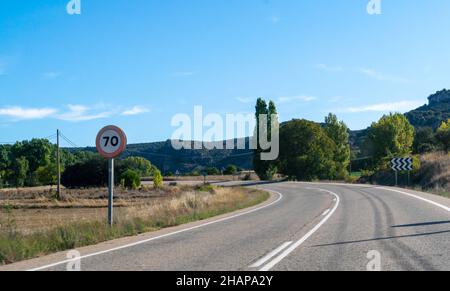Vista di due direzione strada in Spagna con segnale di velocità Foto Stock