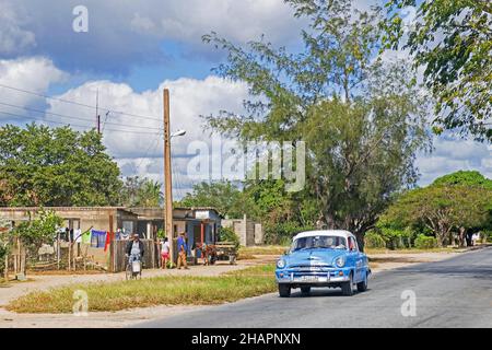 Auto d'epoca americana classica che guida sulla Carretera Central / CC / Central Road, autostrada ovest-est che copre la lunghezza dell'isola di Cuba, Camagü Foto Stock