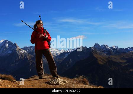 Dolomiten, schöne Frau wandert auf Berge und Felsen am Langkofel, Sasso lungo mit Blick und Aussicht auf die Marmolada, Marmolata in Südtirol Foto Stock