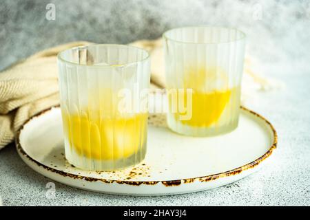 Due bicchieri di cocktail vodka con limone e cubetti di ghiaccio su un tavolo Foto Stock