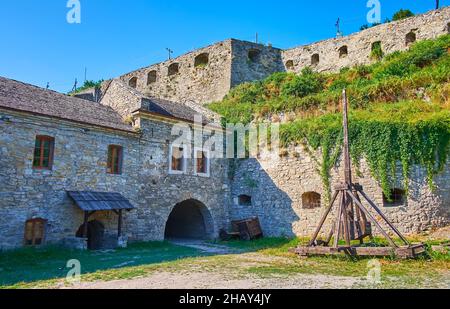 La catapulta in legno di fronte alla fortificazione in pietra medievale della porta russa, Kamianets-Podilskyi, Ucraina Foto Stock