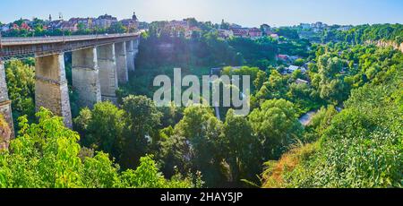Panorama del verde e profondo Smotrych River Canyon con una foresta lussureggiante e storico Ponte nuovo di fronte, Kamianets-Podilskyi, Ucraina Foto Stock