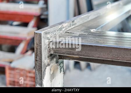 Base del tavolo in metallo saldata da lamiere e tubi rettangolari nella vista del piano d'officina Foto Stock